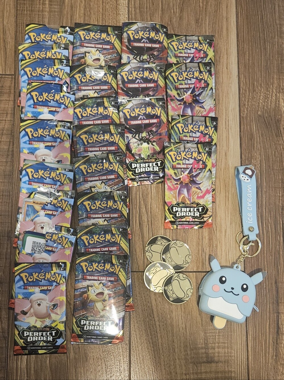 Pokémon Perfect Order Booster Packs + Pikachu Coin & Blue Ice Cream Keychain